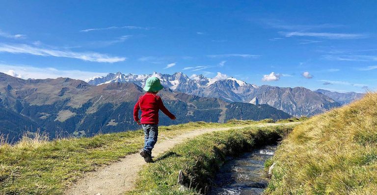 a boy hiking along a biss in Valais