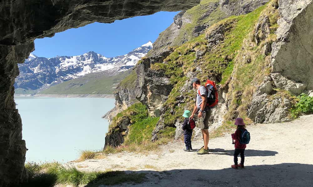a family hiking la Dixence-Dam family hike walking through the tunnel