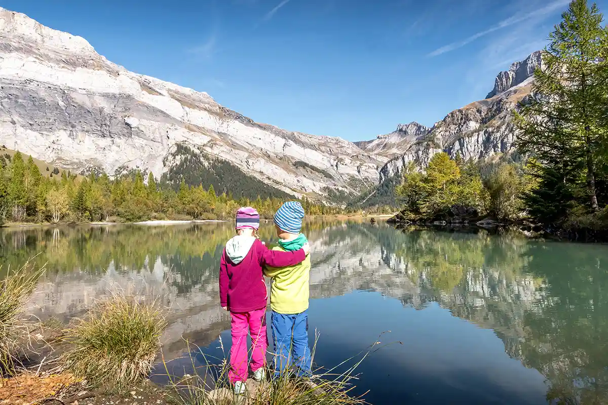 Children at Derborance lake in Valais during autumn