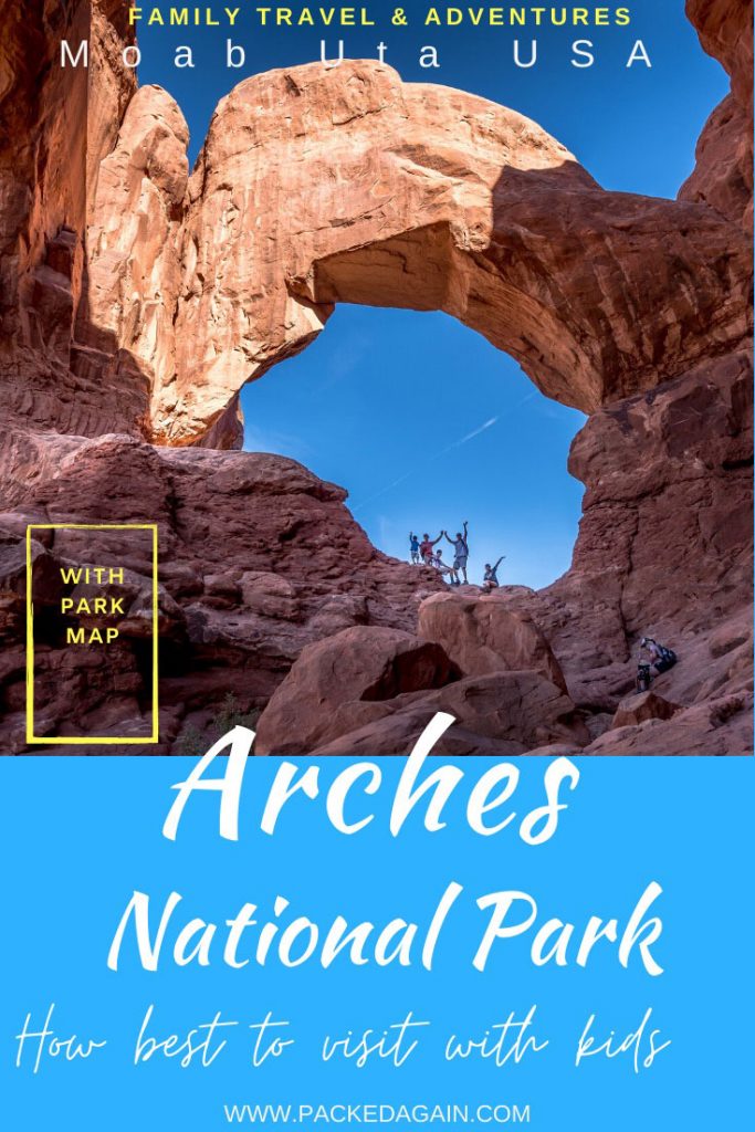 family staying in a massive arch at Arches NP in Utah