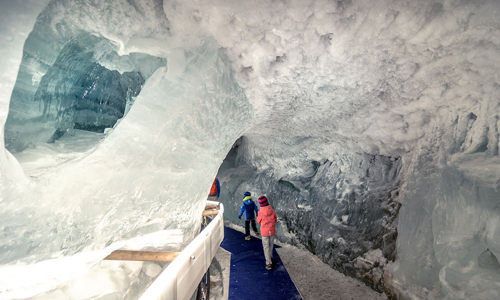Kinder, die im Gletscher am Klein Matterhorn spazieren gehen