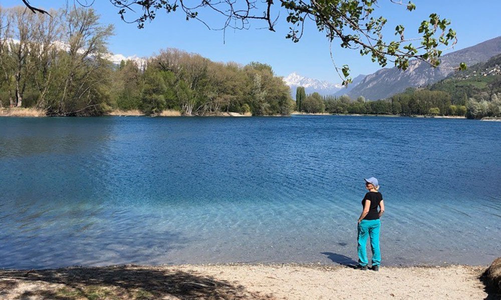 woman by the lake in Les Iles, road trip through Switzerland 