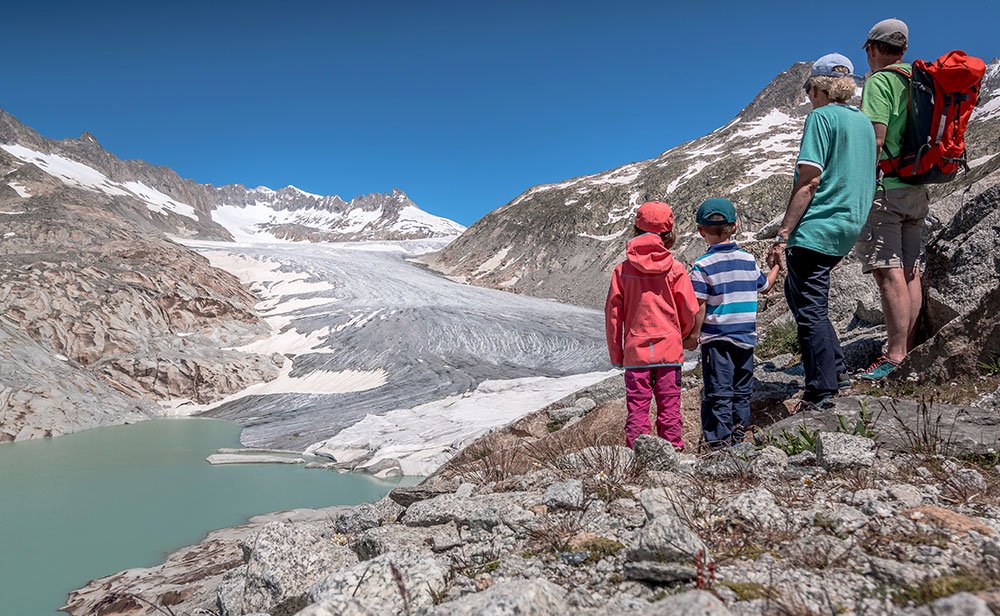 family standing at the Rhone glacier in Valais 