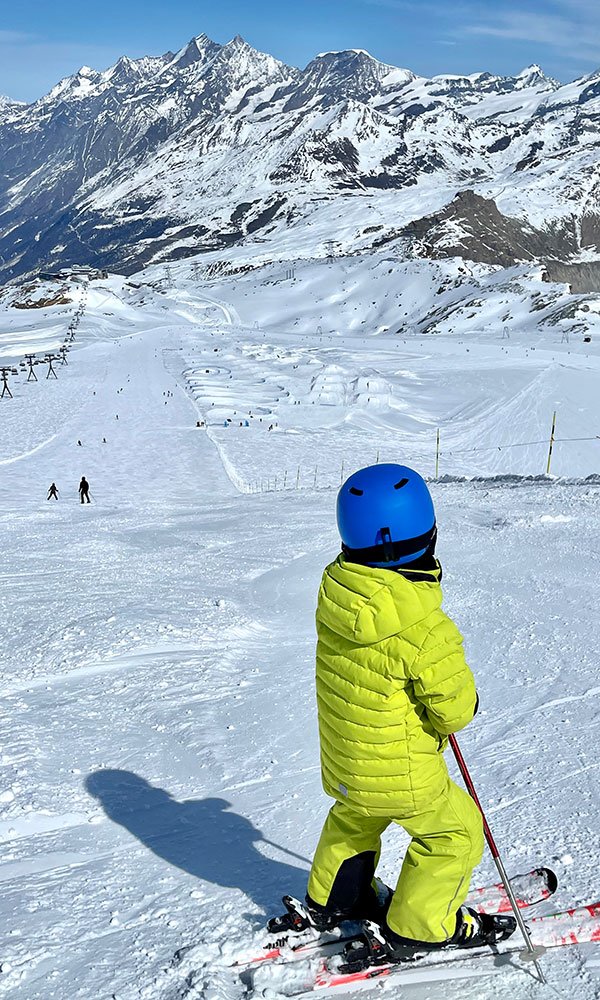 ein Junge, der im Winter den Snowpark in Zermatt betrachtet