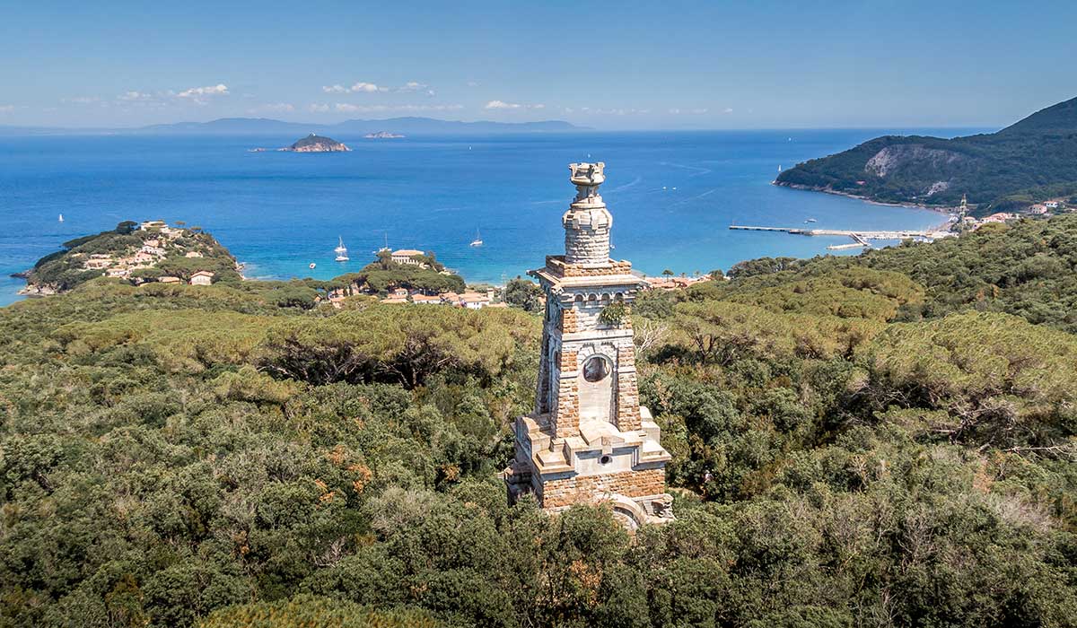 a monsoleum tower in elba with view down to the sea