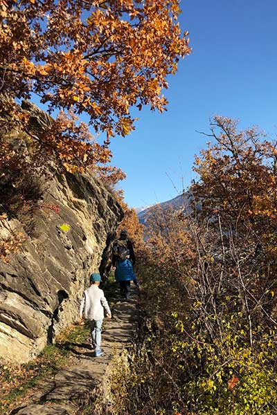 family hiking the siphon bisse in valais