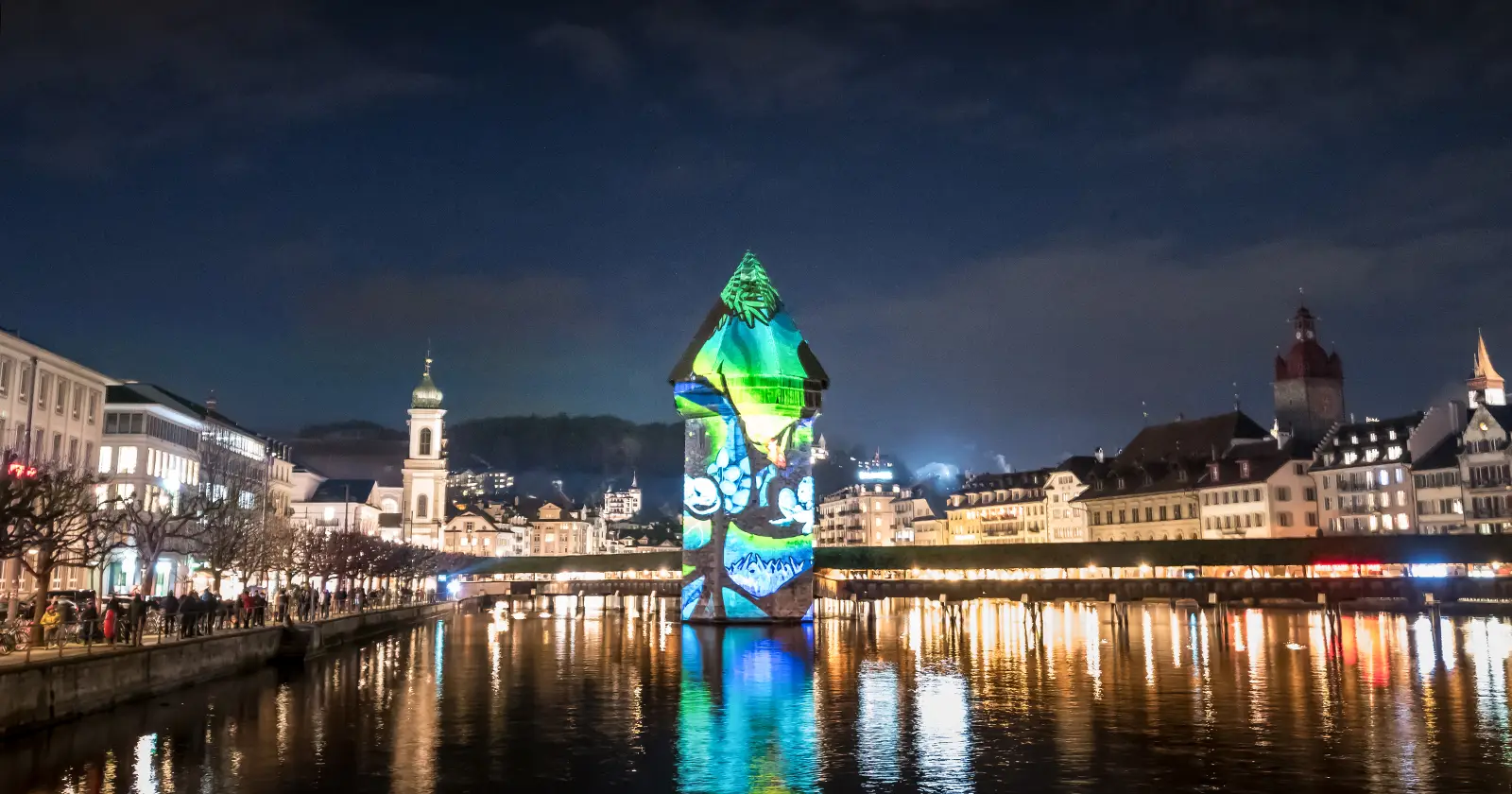 Lucerne Kapelbridge iluminated with blue images at night during the LILI light festival