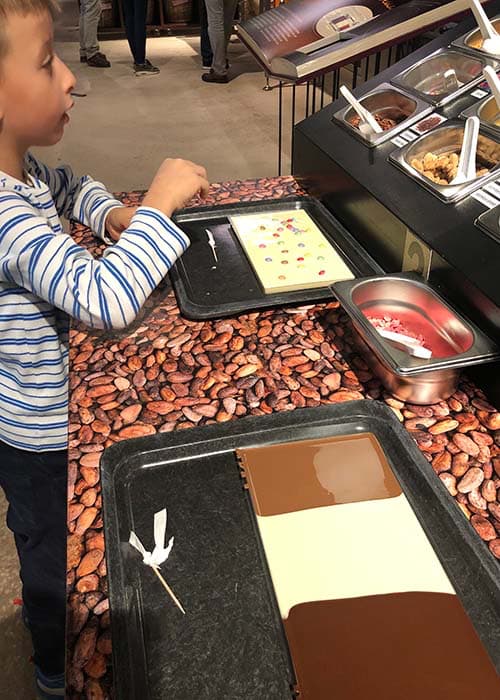 a boy making his own chocolate plaque