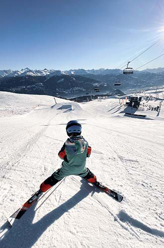a boy in a snow park in the crans montana ski domain