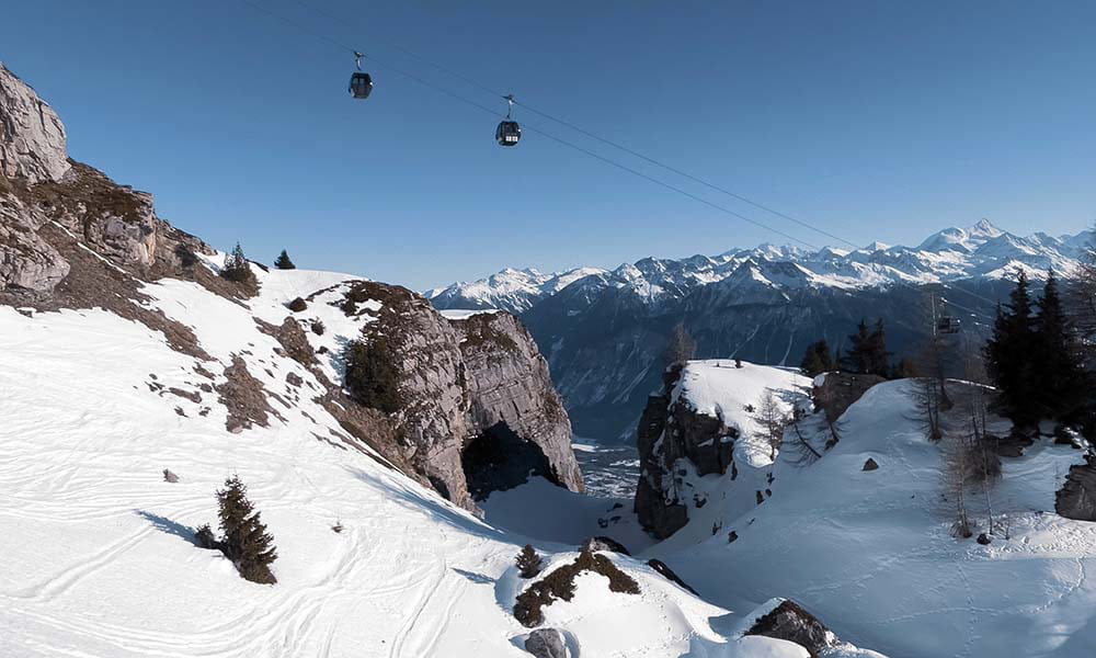 winter scene with gondolas riding up the mountain in crans montana switzerland