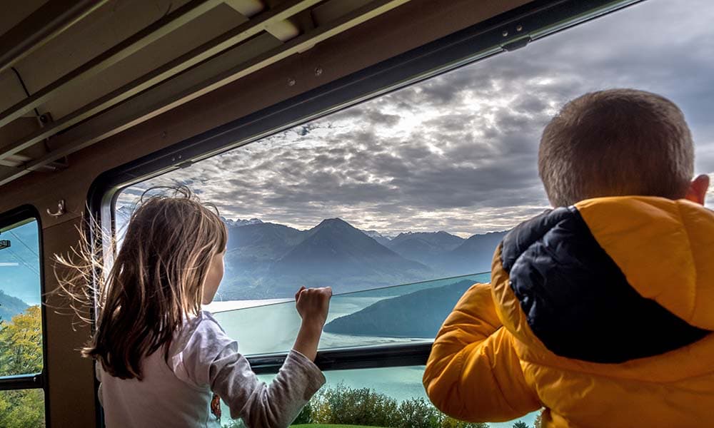 children looking out of train window in Switzerland