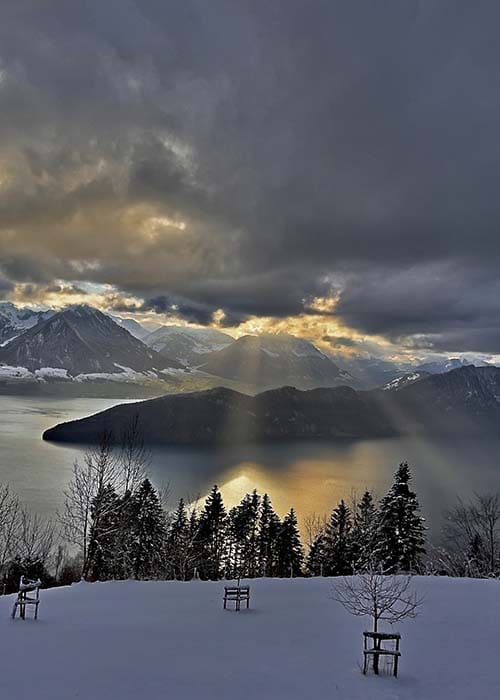 winter dramatic view from train over lake lucerne in switzerland