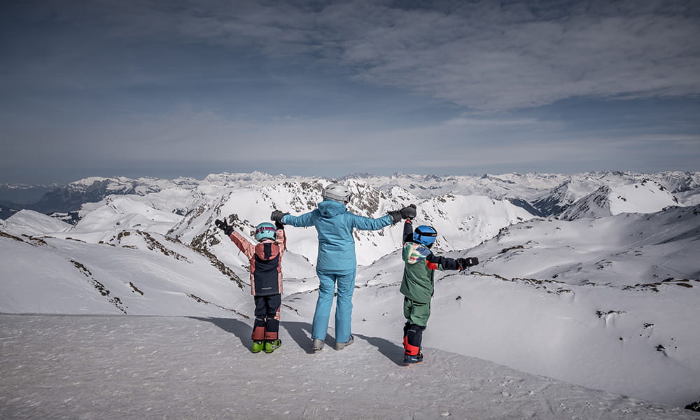 a mum with two kids standing at the top of Arosa mountains 