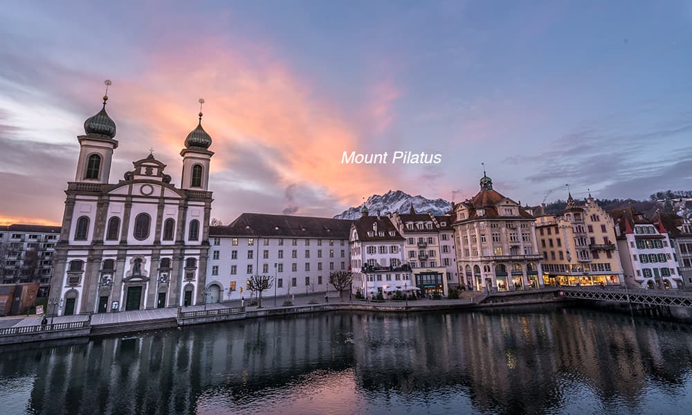 city by night with mount Pilatus in back