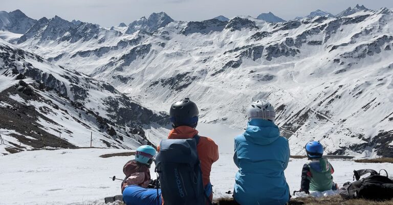 family sitting in a swiss ski resorts in valais