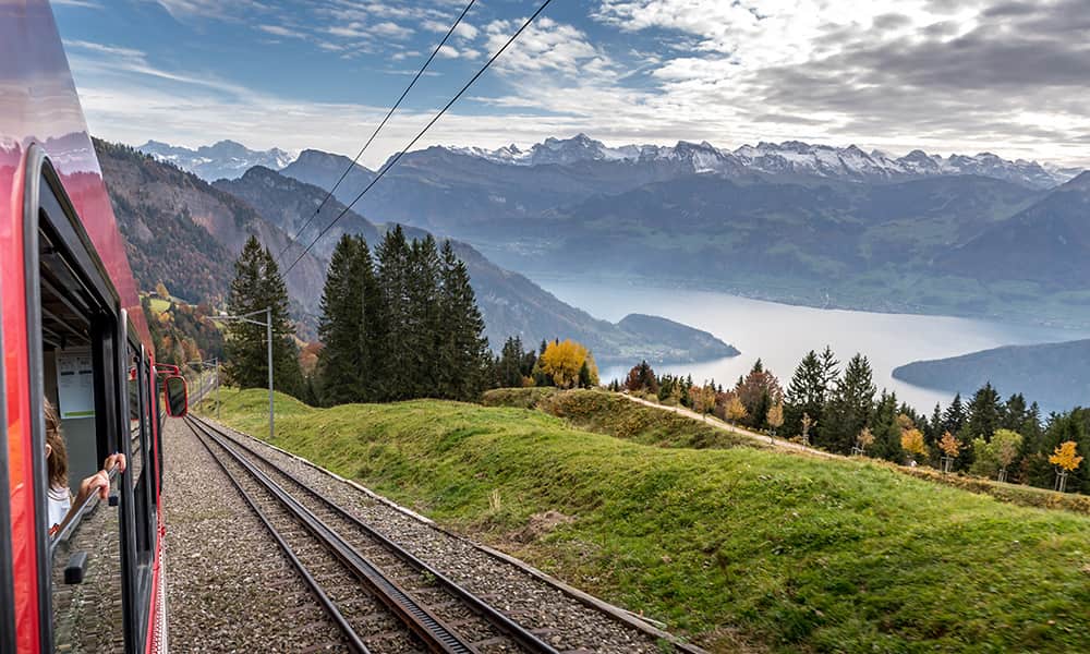 a red swiss train riding up the Rigi