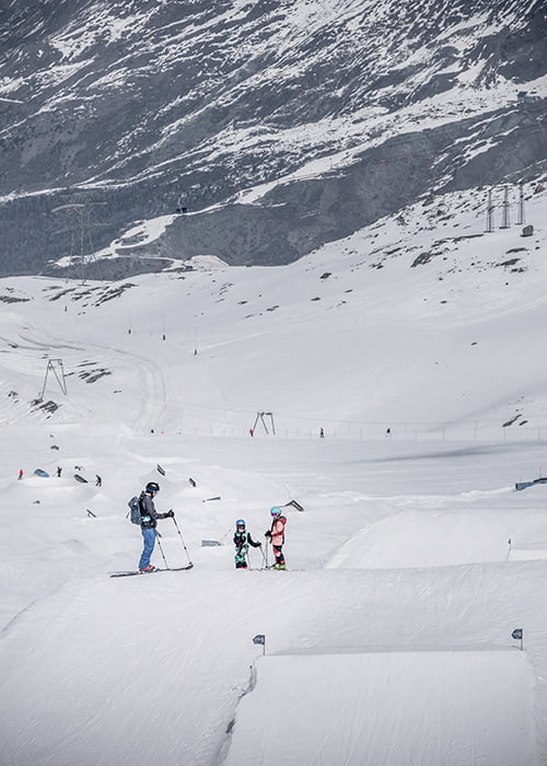a family standing above the zermatt Snow park
