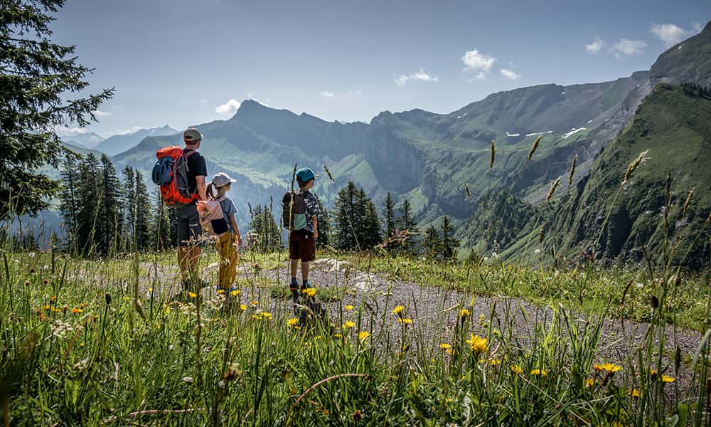 a family hiking in the Klewenalp hills at lake Lucerne