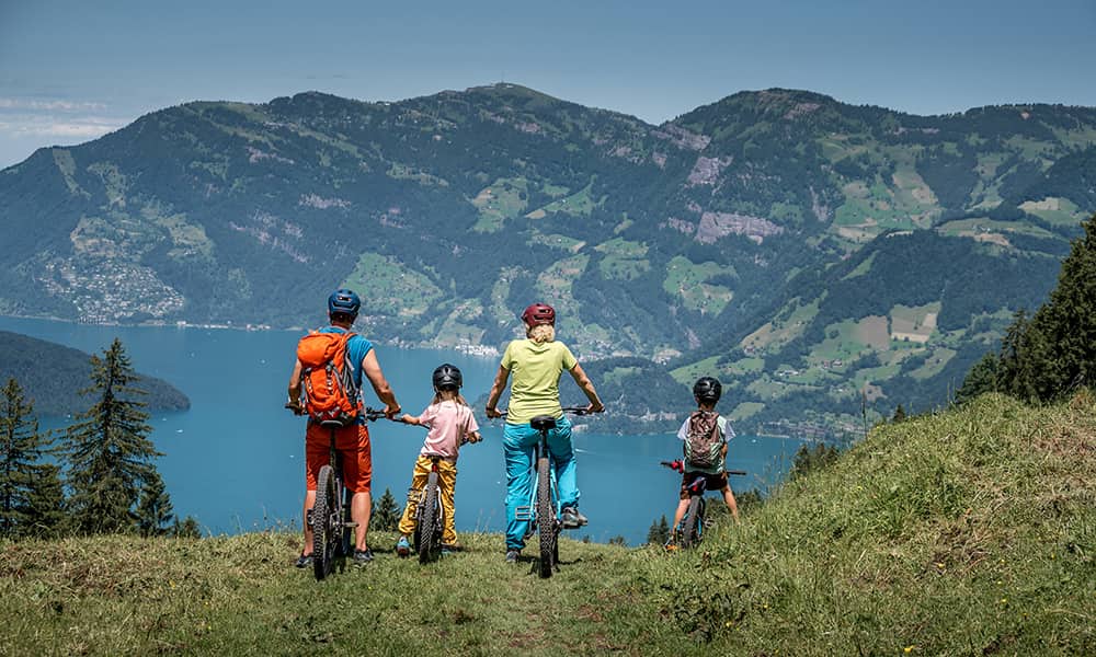 a family on their bikes looking down on to lake lucerne