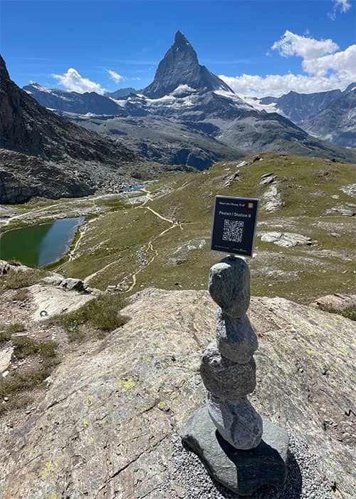 a themed hiking trail signe with the matterhorn in the background