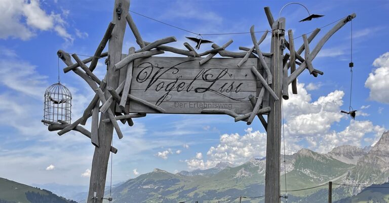 a wooden sign on a hiking trail in Adelboden in Switzerland