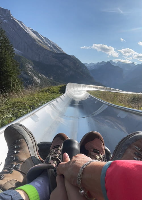 mother and child on the sledge at the sledge run in Oeschinensee