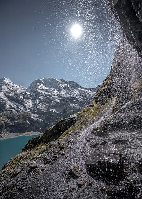 waterfall at the oeschinensee swiss alpine lake