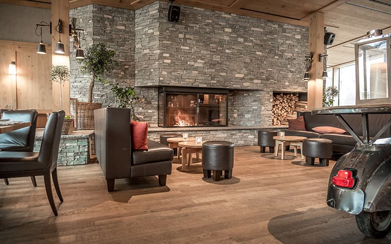 hotel lounge and bar with fire place at Frutt Mountain resort
