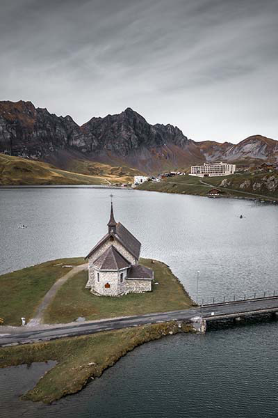 areal view of the church at Melchsee Frutt with the Frutt Hotel in the background