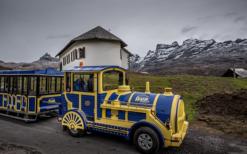 Blue and yellow tourist train at Melchsee-Frutt in Switzerland