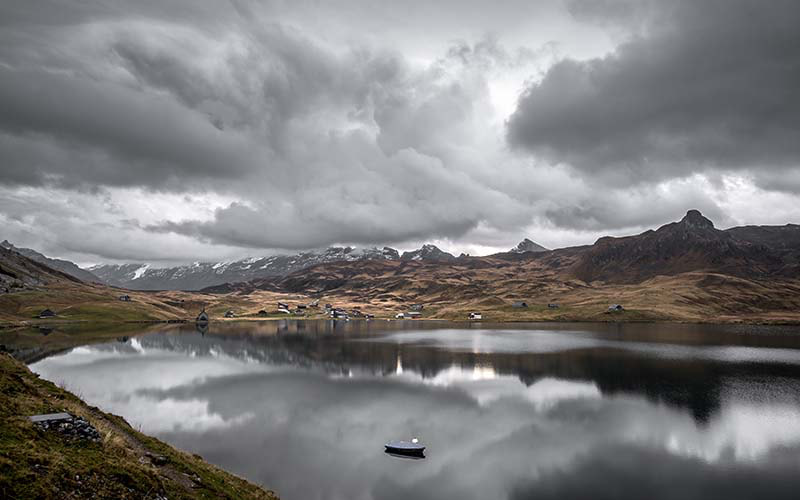 Lake Melchsee in the Swiss alps during a cloudy grey autumn morning 