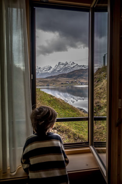 a boy looking out of his room window in the frutt resort