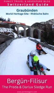 family sledging on europe's longest floodlight sledge run the Preda Bergün run in Switzerland