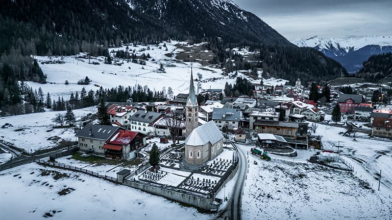 snowy village of Bergün from a drone view