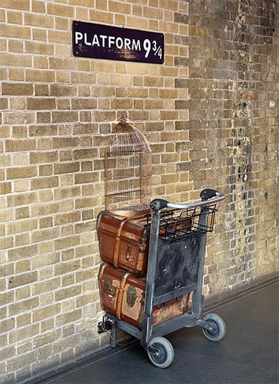 the trolley of harry potters movie at Platform 9 3/4 with suitcases on it