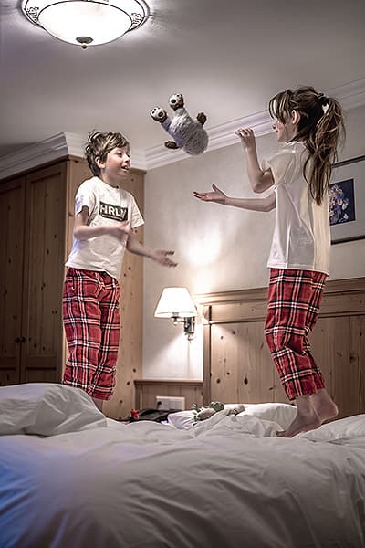children jumping on hotel beds