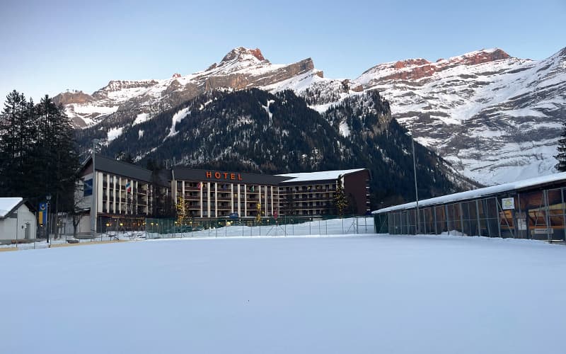 Swiss hotel in front of a mountain during a winter day