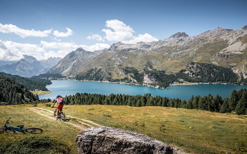 a biker on his bike close to lake Silsee in St. Moritz 