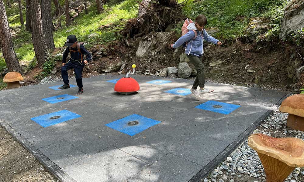 children hoping on lights balls in the forest