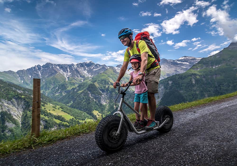 a father and his daughter on a monster scooter in Elm Glarus