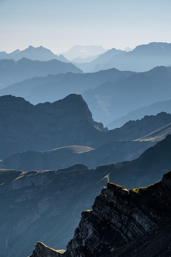 blue layers over mountains on sunrise