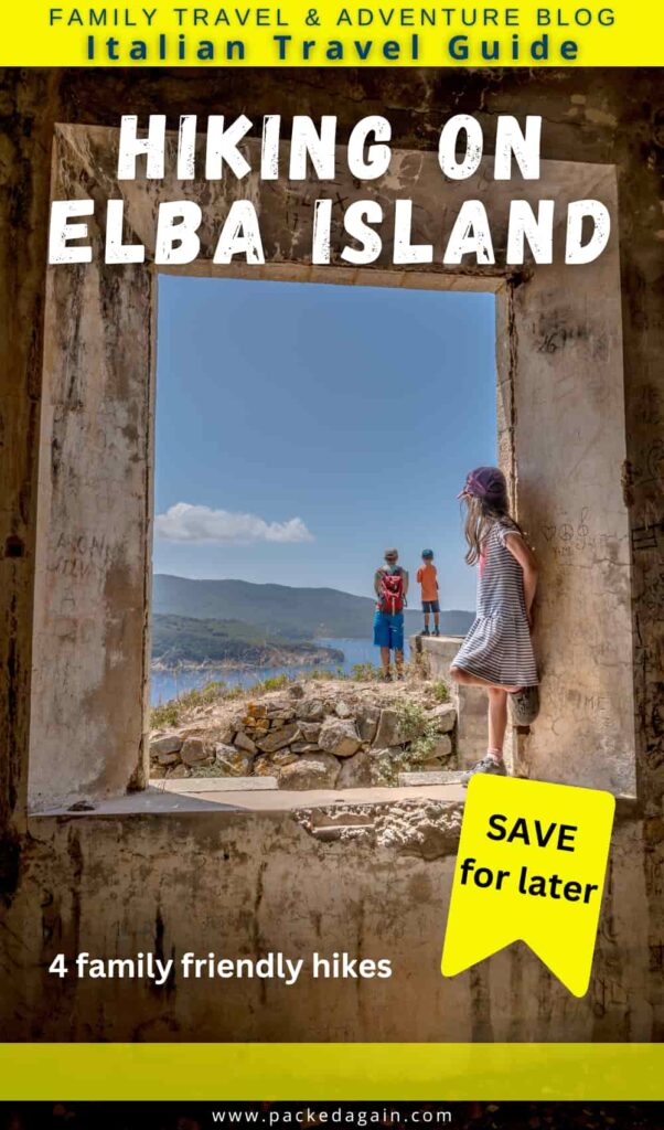 a family standing within an old door frame over looking the Italian island of Elba on a hiking trail