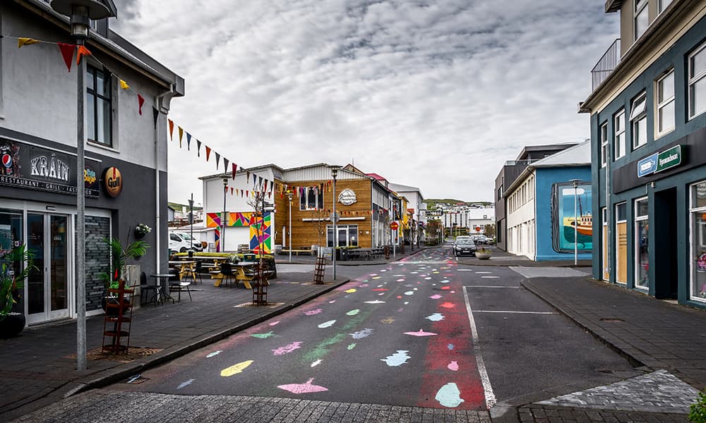 centre of the village heimaey with colourfull fish paintings on the street