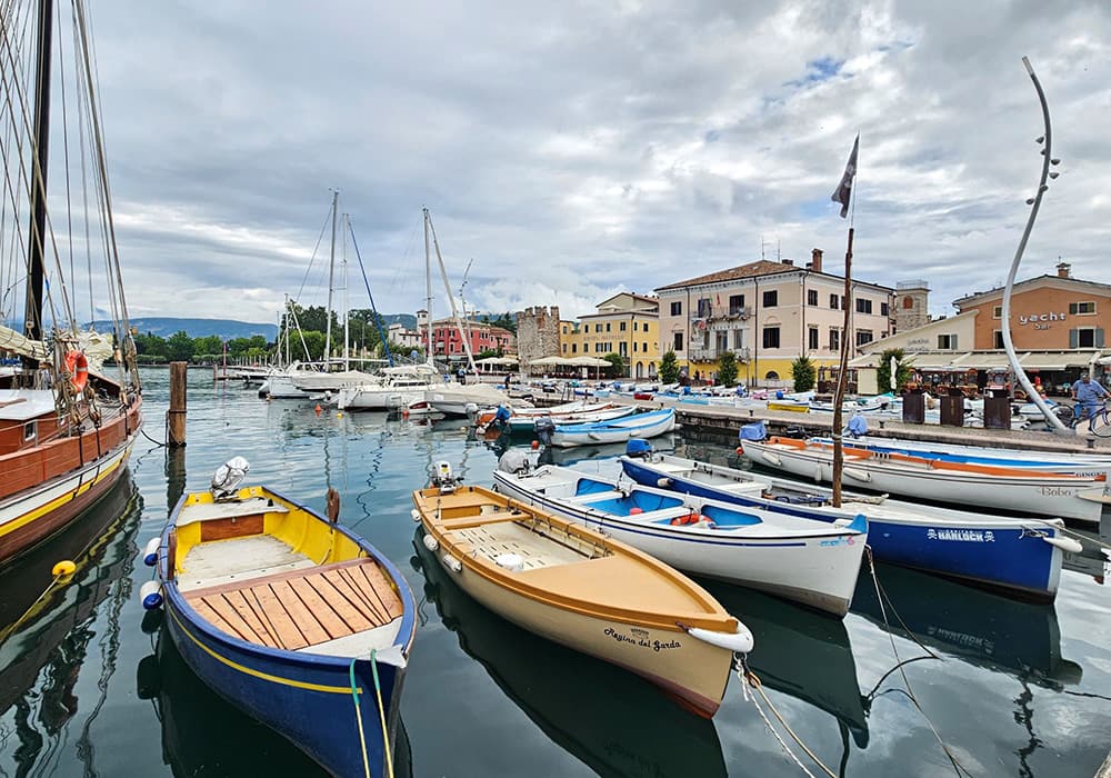 fishing boats at bardolino pier with a cloudy background