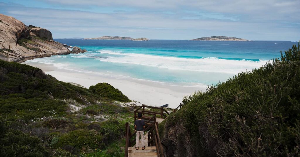 Australian beach with white sand and green bushes