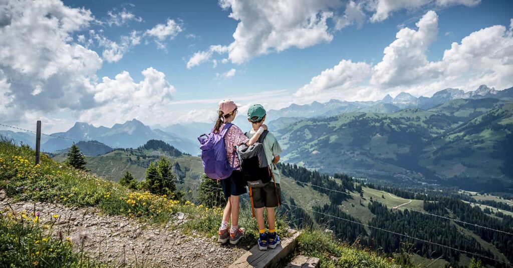 children hiking in Switzerland on the trail in Gstaad
