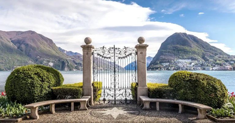 gate into the lake lugano with a mountain at the end