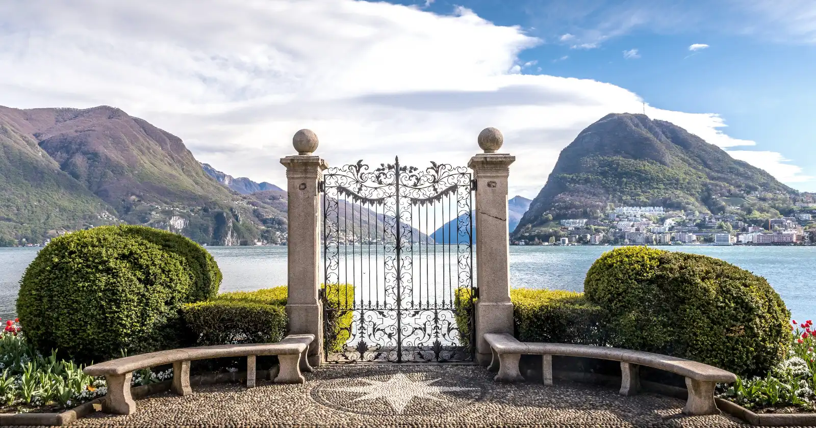 gate into the lake lugano with a mountain at the end