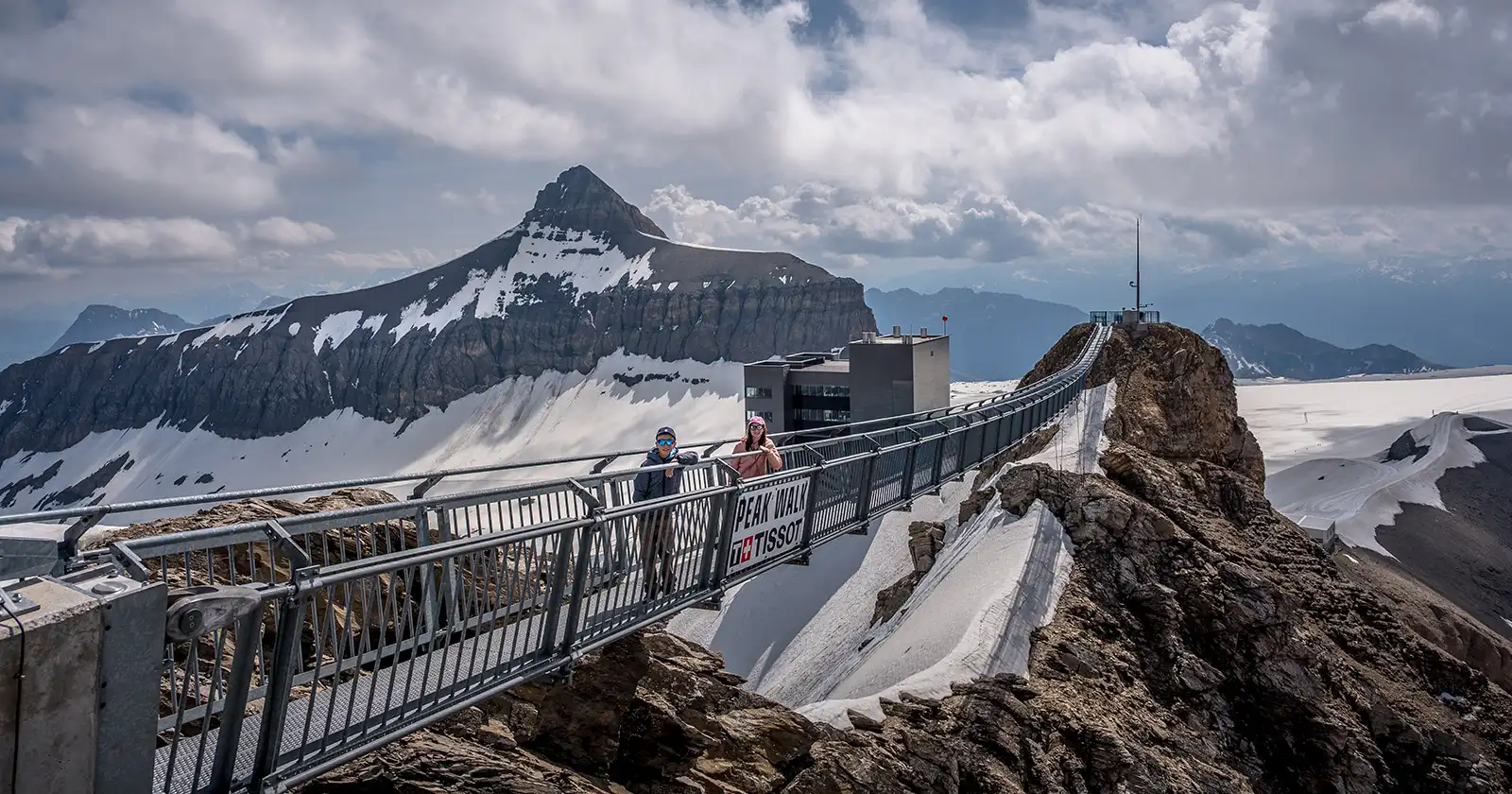 two children standing on the Tissot Peak to Peak bridge at Glacier 3000