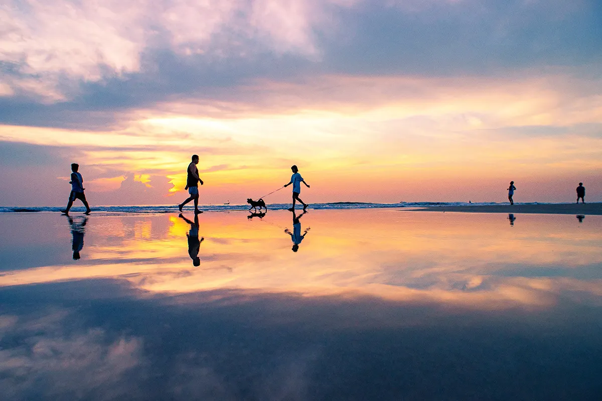 persons walking on water during a sunset